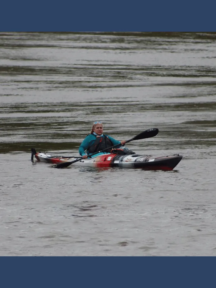 Sher in her kayak paddling