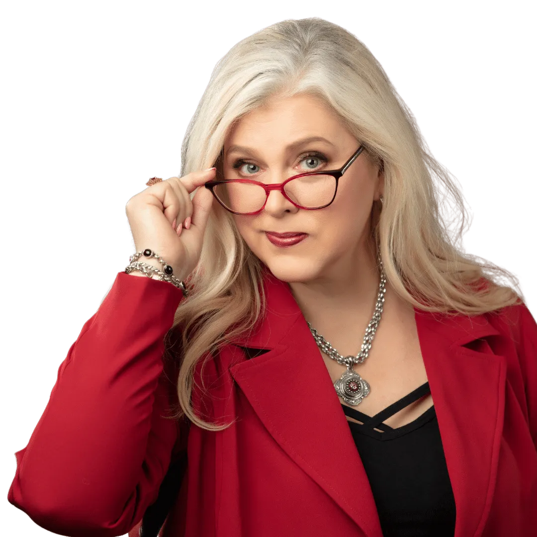 Sheral DeVaughn wearing a red jacket and peering over the top of her black glasses